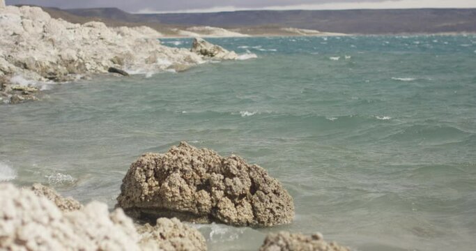 waves crashing on the rocks in a windy bay