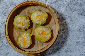 dim sum, Hong Kong steamed siew mai meatball dumplings with dumpling skin in bamboo basket asian dim sum menu