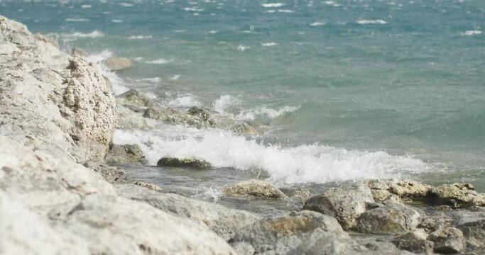 waves crashing on the shore of a lake on a windy day