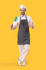 Male chef with flag of Italy showing thumb-up on yellow background