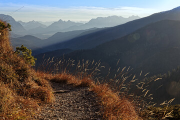 Mountain path and panorama of the Bavarian and Tyrolean Alps, view from Herzogstand in the late...