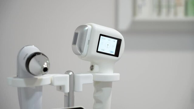 Modern technology woman hand turn on depilation equipment for laser hair removal close up. Laser procedure in epilation beauty studio or clinic, body care hair removal