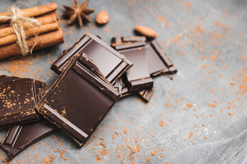 Heap of delicious dark chocolate pieces or cubes, chopped, broken chocolate bar, almond nut,...