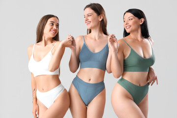 Beautiful women in underwear on light background