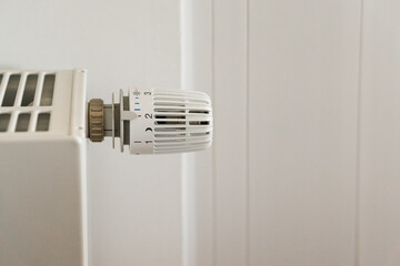 White radiator in home focused on the thermostat - obrazy, fototapety, plakaty
