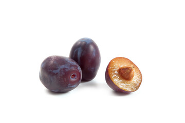 Two Whole and Halves purple plums isolated on white background. .
