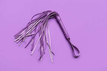 Whip from sex shop on purple background