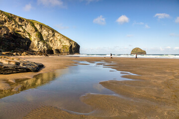 Trebarwith Strand, Cornwall, UK - Dog walkers on the beach at low tide.