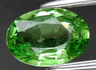 natural green tsavorite garnet gem on the background