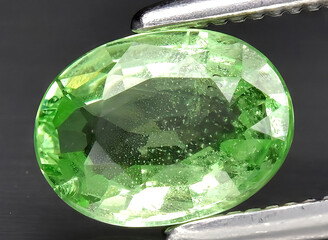 natural green tsavorite garnet gem on the background