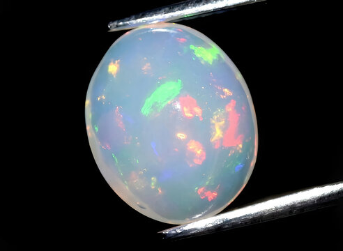 natural multi color rainbow opal gem on the background