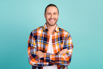 Portrait of toothy beaming guy with beard long hairdo wear flannel shirt arms folded smiling isolated on turquoise color background