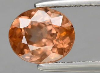natural orange zircon gem on the background