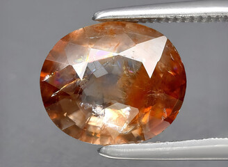 natural orange zircon gem on the background