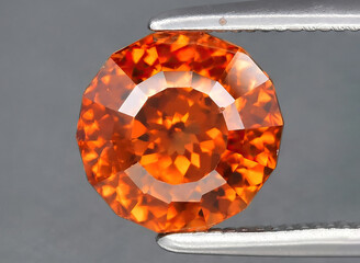 natural orange zircon gem on the background