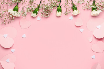 White carnations with gypsophila flowers and paper hearts on pink background. Valentine's day concept