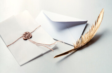 Golden pen and stamped envelope