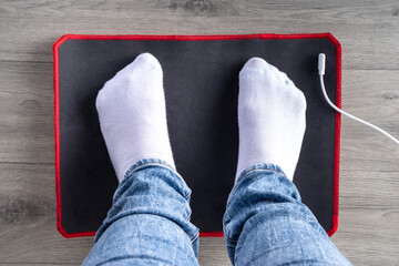 Grounding Mat concept. Home Using wellbeing, wellness electric charge mat with woman foots it pic