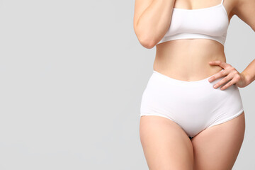 Fototapeta na wymiar Body positive woman in underwear on light background, closeup