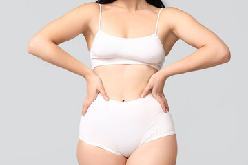 Fototapeta na wymiar Body positive woman in underwear on light background, closeup