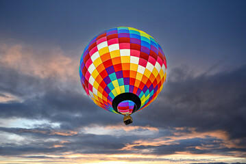Colorful hot air balloon flying at sunset
