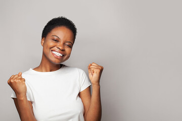 Surprised happy woman smiling and having fun against white studio wall background, emotional...