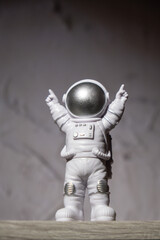 Plastic toy figure astronaut on moon concrete background Copy space. Concept of out of earth travel, private spaceman commercial flights. Space missions and Sustainability