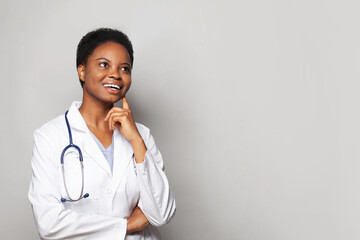 Optimistic happy doctor woman medical worker in lab coat on white background
