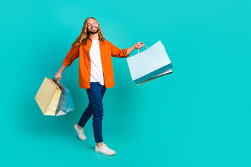 Full body size photo of funky blond hair man strolling in shopping mall with eco friendly packages...