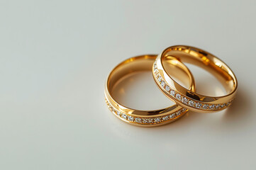 a gold rings with gems or diamonds on a white background, copy space for text, wedding or engagement couple rings, Valentine's Day,