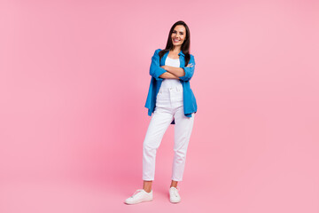 Full size photo of satisfied optimistic girl dressed blue shirt white trousers keep palms folded isolated on pink color background