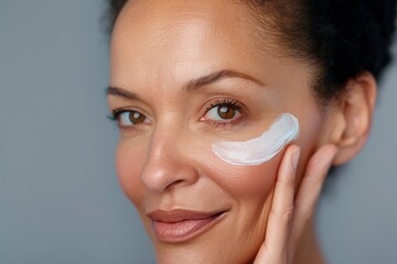 Close-up photo of adult woman touching her skin, she applies moisturizing cream balm. Cosmetology, plastic surgery, healthy lifestyle. Radiant skin. Advertising of cream, skin health products