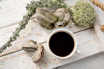 Mushroom coffee chaga superfood. Dried mushrooms and and a cup of coffee. Healthy organic...