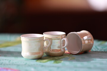 Three beautiful ceramic cups with flowers.