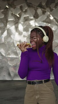 Cool african woman with vitiligo singing listening to music outdoors