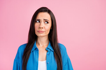 Photo of gloomy confused girl with straight hairdo dressed blue shirt look at proposition empty...