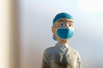 miniature figure portrait of a surgeon with a medical mask