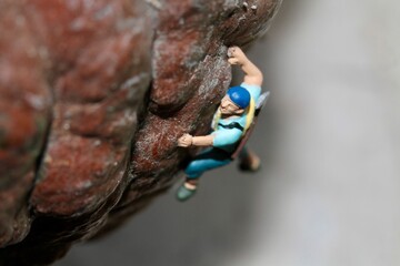 miniature figurine of a climber on a mountain