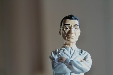 miniature figure portrait of a doctor  with arms crossed