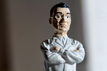 miniature figure portrait of a doctor  with arms crossed