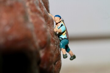 miniature figurine of a climber on a mountain
