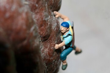 miniature figurine of a climber on a mountain