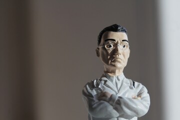 miniature figure portrait of a doctor  with arms crossed