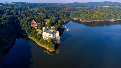 Aerial view of Orlik castle over Orlik reservoir. Beautiful gothic landmark over the lake. Orlik...