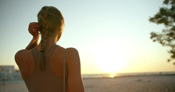 Portrait of a beautiful young athletic girl enjoying the sunrise