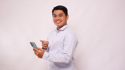 Asian man clenched fist showing excitement when looking to his phone