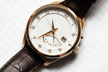Classic wrist watch with white clock wace and golden hands