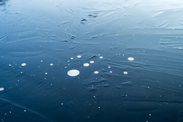 Dark blue surface with white droplets