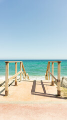 wooden stair leading to an idyllic beach. Mediterranean, Barcelona