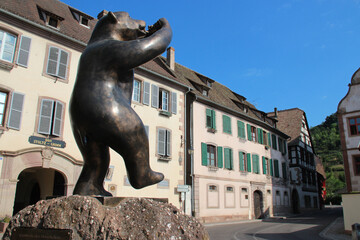 bronze statue of a bear and habitation buildings andlau in alsace in france